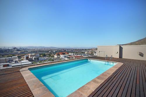 a swimming pool on the roof of a building at Urban Oasis At The Four Seasons in Cape Town