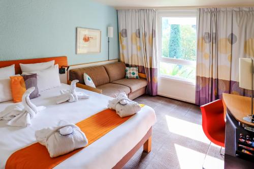 a hotel room with a bed with towels on it at Novotel Marseille Est Porte d'Aubagne in Marseille