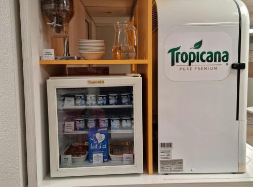 an open refrigerator with food inside of it at Premiere Classe Honfleur in Honfleur