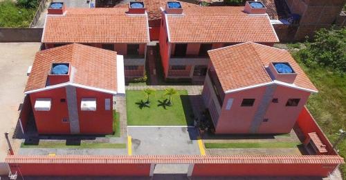 an overhead view of a house with red roofs at Casa Lua Cheia na Praia de Peroba, Maragogi in Maragogi