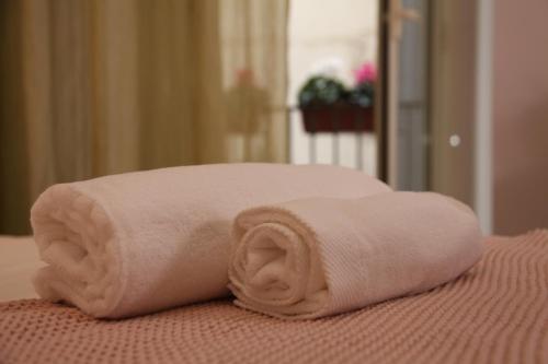 uma toalha enrolada em cima de uma cama em Soraya em Nápoles