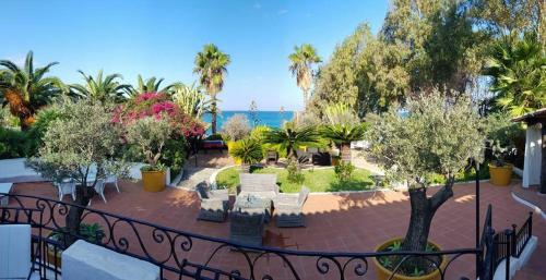 a balcony with a view of a park and the ocean at Residenza Villa Spagnola in Parghelia