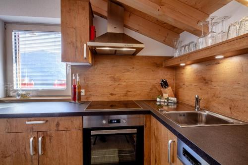 a kitchen with a sink and a stove at Bergchalet Haflingerherz in Wenns