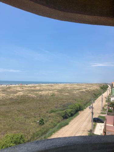 a view of the beach from a window at Residencial Beira Mar in Cassino