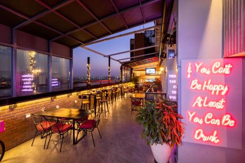 a restaurant with tables and chairs on a balcony at ibis Bengaluru City Centre - An Accor Brand in Bengaluru