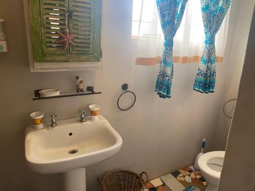 a bathroom with a sink and a toilet at Magaliesberg inn in Rustenburg