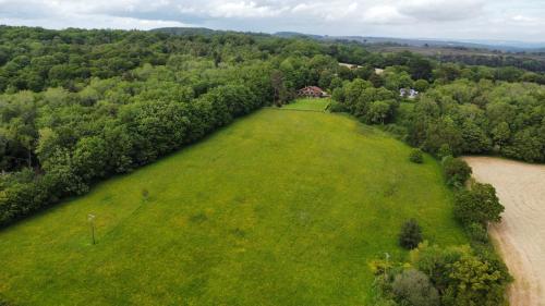 an aerial view of a large grassy field next to a river at Seven Acre Corner B&B in Exmouth