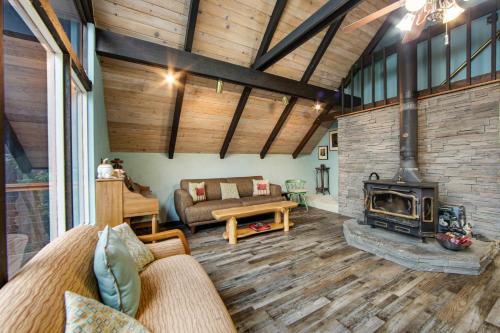 a living room with a fireplace and a couch at Cabin on a Hill in Idyllwild