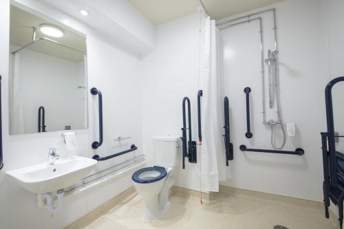 a bathroom with a toilet and a sink at The Raven’s Cliff Lodge by Marston's Inns in Motherwell