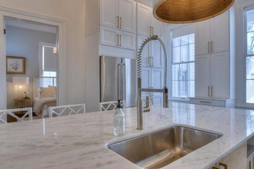 a kitchen with a sink and a counter top at The White House Galveston in Galveston