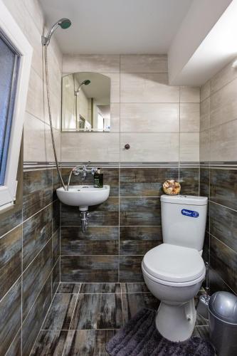 a bathroom with a toilet and a sink at Top Center Vintage Sofia Condo in Sofia