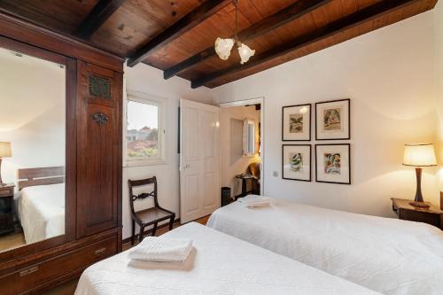 a bedroom with two beds and a window at Quinta Florença - By WeHost in Funchal
