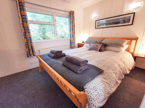 a bedroom with a bed with towels on it at Kelpie in Lochgilphead