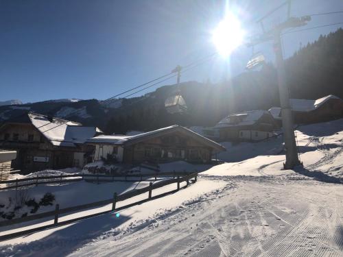 a ski resort with a ski lift in the snow at Bergdorf Riesner in Donnersbachwald