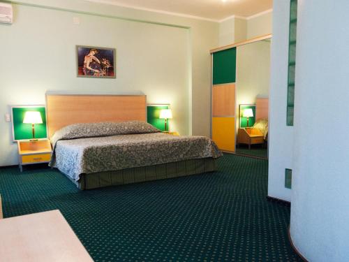 A bed or beds in a room at Maxima Irbis Hotel