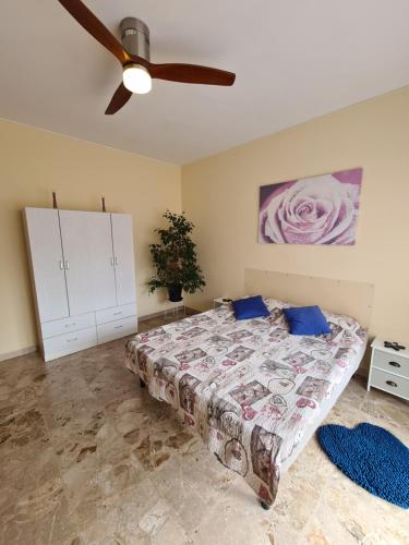 um quarto com uma cama e uma ventoinha de tecto em Casa dell amore 2 em Sanremo