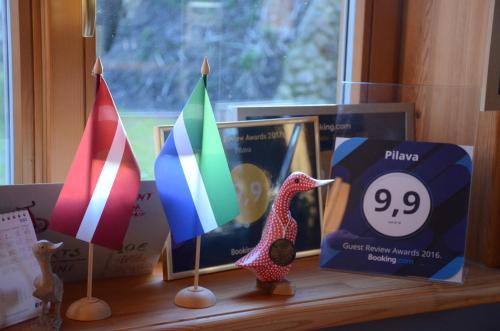 a window sill with flags on a table at Pilava in Roja