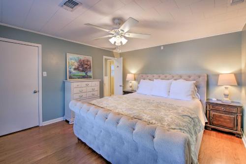 a bedroom with a large bed and a ceiling fan at Waterfront Getaway with Dock on Lake Hamilton! in Lake Hamilton