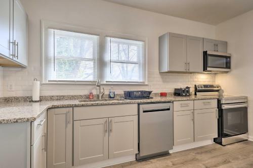 a kitchen with white cabinets and white appliances at Inviting Home, 1 Mi to High Point University! in High Point