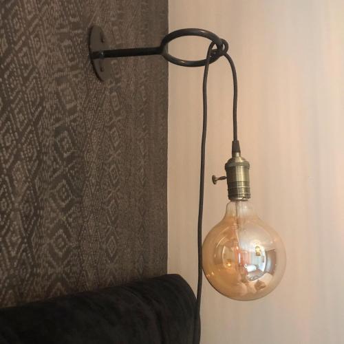 a glass light bulb hanging from a wall at Fever Tree Guesthouse in Hillcrest
