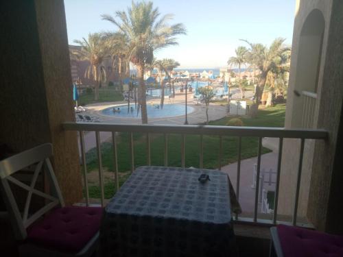 a balcony with a table and a view of a pool at One Bedroom Chalet at Porto South Beach Families only in Ain Sokhna