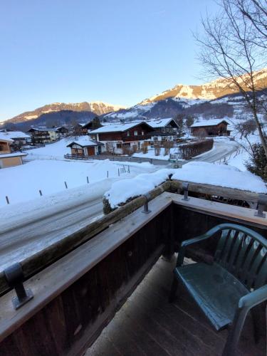 a bench sitting on top of a snow covered roof at Ferienhotel Alpenhof in Aurach bei Kitzbuhel