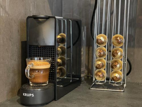 a coffee maker with a cup of coffee and pastries at FONTAINE ROUGE STREET Marne la Vallée Disneyland Paris Outlet Mode And luxury Village Val d'europe FREE PARKING in Chessy