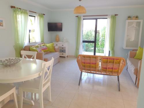 a living room with a table and a couch at Algarve Apartment Falésia in Albufeira