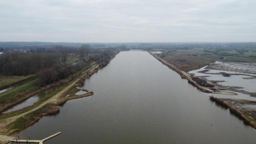 an aerial view of a river with trees and fields at Hotel Het Buskruid in Lummen