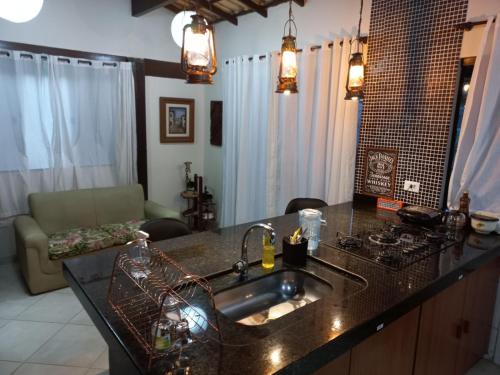 a kitchen with a sink and a counter top at Ilha do Village in Cabo Frio