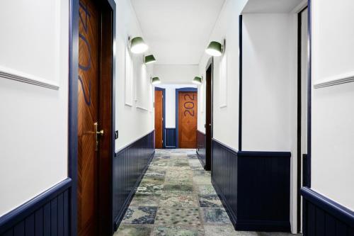 a hallway with doors and a tile floor at Generator Rome in Rome