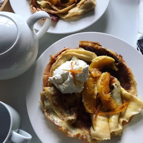 a pie on a plate next to a cup of coffee at Willa A.D.1894 in Łeba