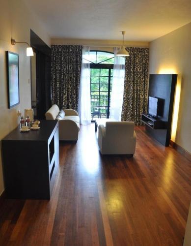 a living room with a couch and a table at Strawberry Park Resort in Cameron Highlands