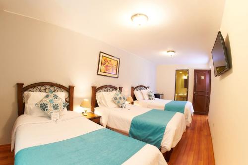 Ένα ή περισσότερα κρεβάτια σε δωμάτιο στο Hotel Los Tambos Colonial