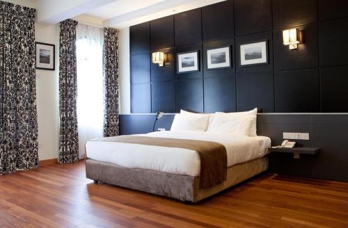 a bedroom with a large bed with a black wall at Strawberry Park Resort in Cameron Highlands