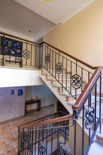a spiral staircase in a house with a stair case at Hostal Nordés in Oaxaca City