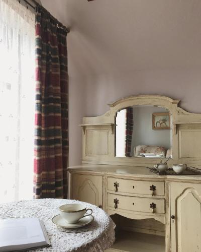 a bedroom with a dresser with a mirror on it at Willa A.D.1894 in Łeba
