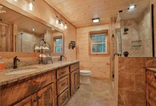 a bathroom with a sink and a shower and a toilet at Mountain Hideaway with Hot Tub & Fire Pit in Mineral Bluff
