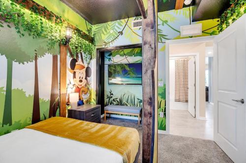 a bedroom with a jungle themed bedroom with a bed at NEW Magically Themed Condo w Pool View in Kissimmee