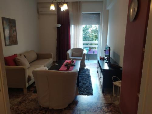 a living room with a couch and a table at Maria's Cozy apartment in Palaio Faliro in Athens