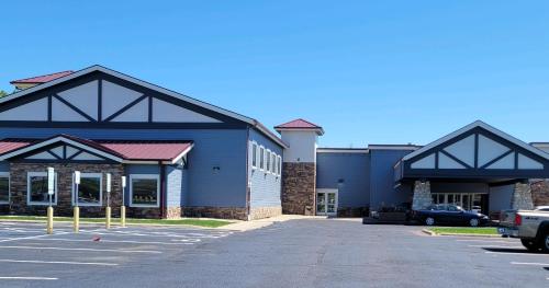 a blue building with a car parked in a parking lot at The Dakota in Sioux Falls