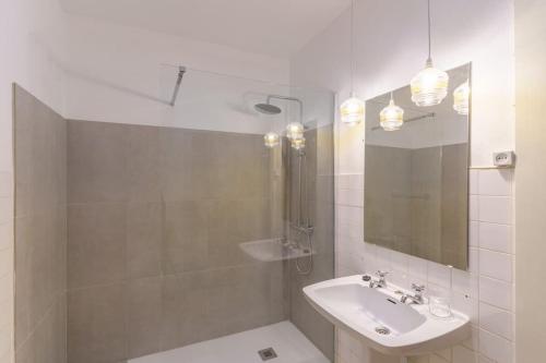 a white bathroom with a sink and a mirror at Quinta de Villa Franca - Douro in Peso da Régua