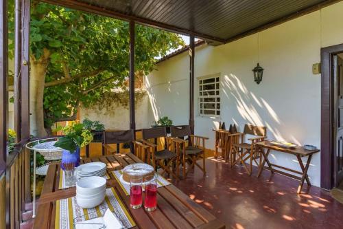 a patio with a table and chairs on a porch at Quinta de Villa Franca - Douro in Peso da Régua