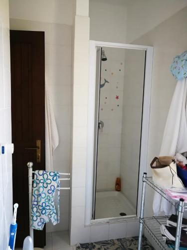 a bathroom with a shower with a mirror at Villa La Pelosa Stintino in Stintino
