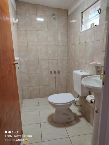 a bathroom with a toilet and a sink at El Tata in Recreo