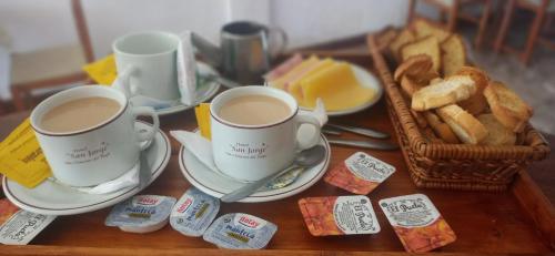 two cups of coffee and bread on a table at HOTEL SAN JORGE in San Clemente
