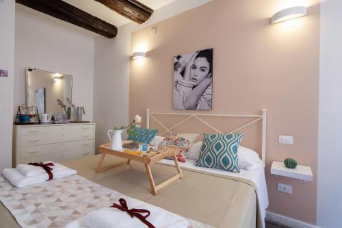 a bedroom with a bed and a dresser at Ciao Bella Divas in Riomaggiore