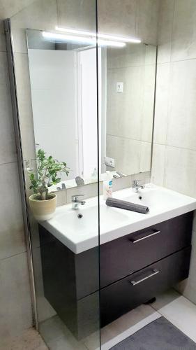 a bathroom with a sink and a mirror at Ocean View Apartments in Adeje