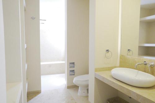 a bathroom with a sink and a toilet at 2063 - Lu Iba Condo 2 in Tangolunda