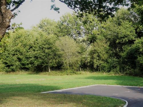 an empty parking lot in a park with trees at Jolie longère près Canal Nantes-Brest ' Pétanque in Guenrouet
